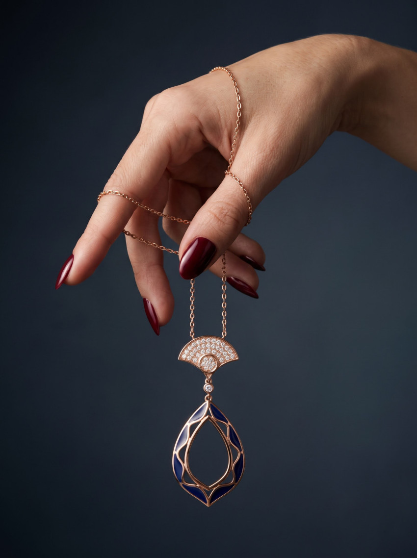 Gold Pendant Suspended by Hand Jewelry Photography Prompt - Example 1