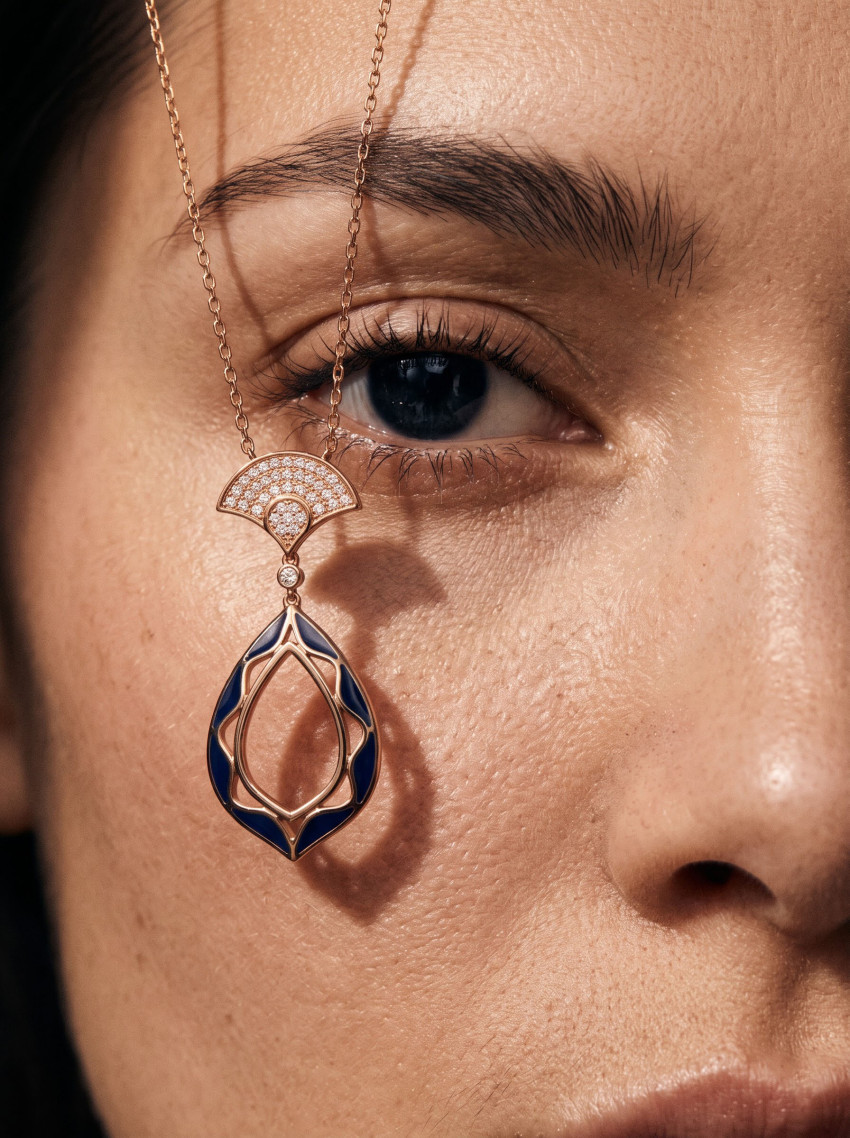 Close-Up Eye and Dangling Gold Pendant Jewelry Photography Prompt - Example 1