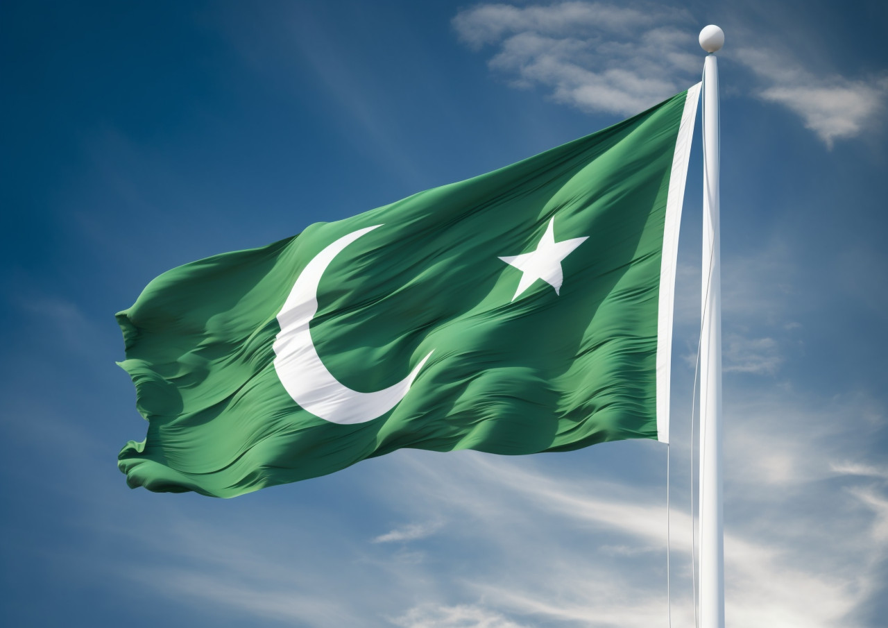 Pakistan flag displayed against a blue sky, pakistan independence day photos