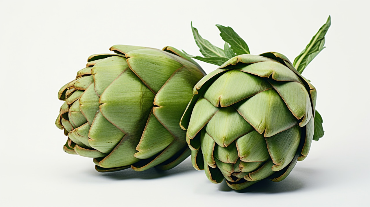 A pair of green artichokes on a white surface, artichoke image