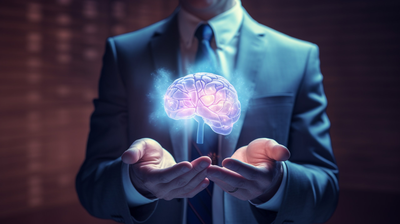 A businessman with a brain on his hand holding up paper, human brain image