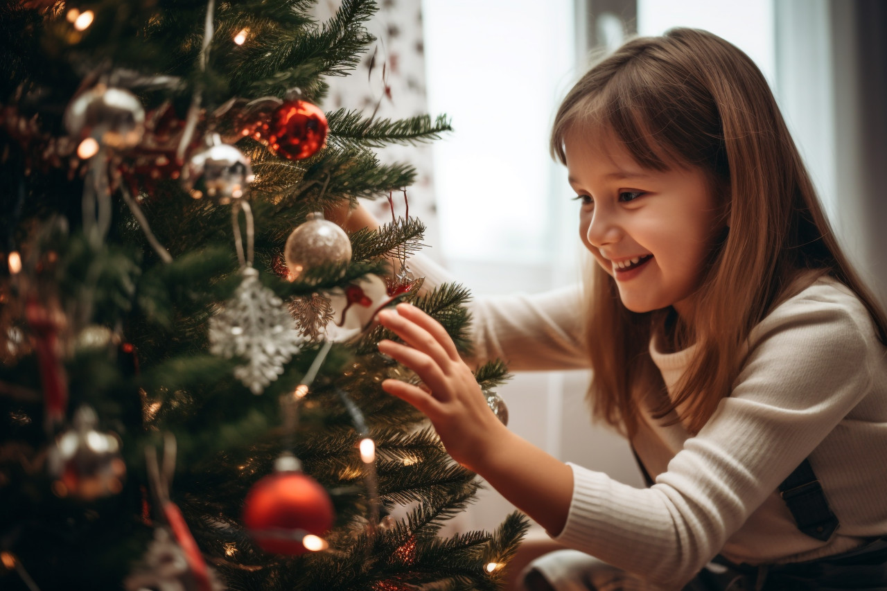 A picture of a mother and her daughter decorating a christmas tree at home during the winter holidays, christmas festival people image