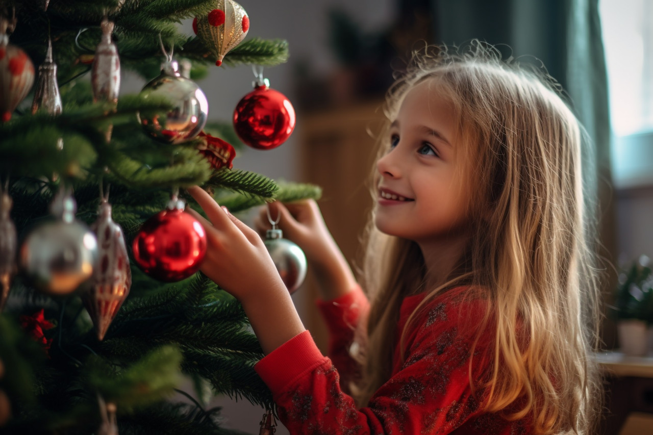 A picture of a pretty young girl decorating the christmas tree, christmas festival people image