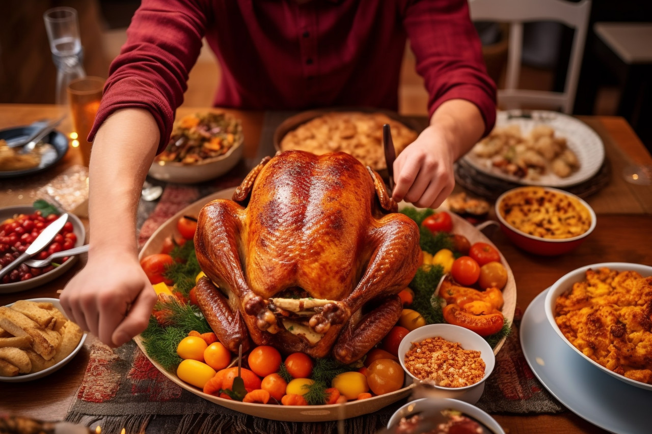 A photo of a young man placing a dish of roasted turkey on a holiday dinner table for a christmas family party, christmas festival people image