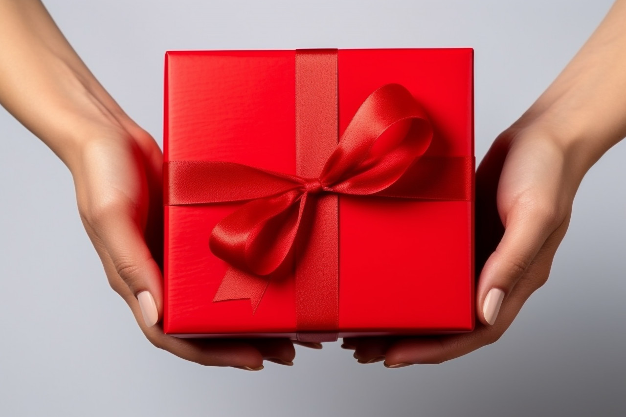 A picture of a woman holding a red empty box for a holiday like christmas or thanksgiving