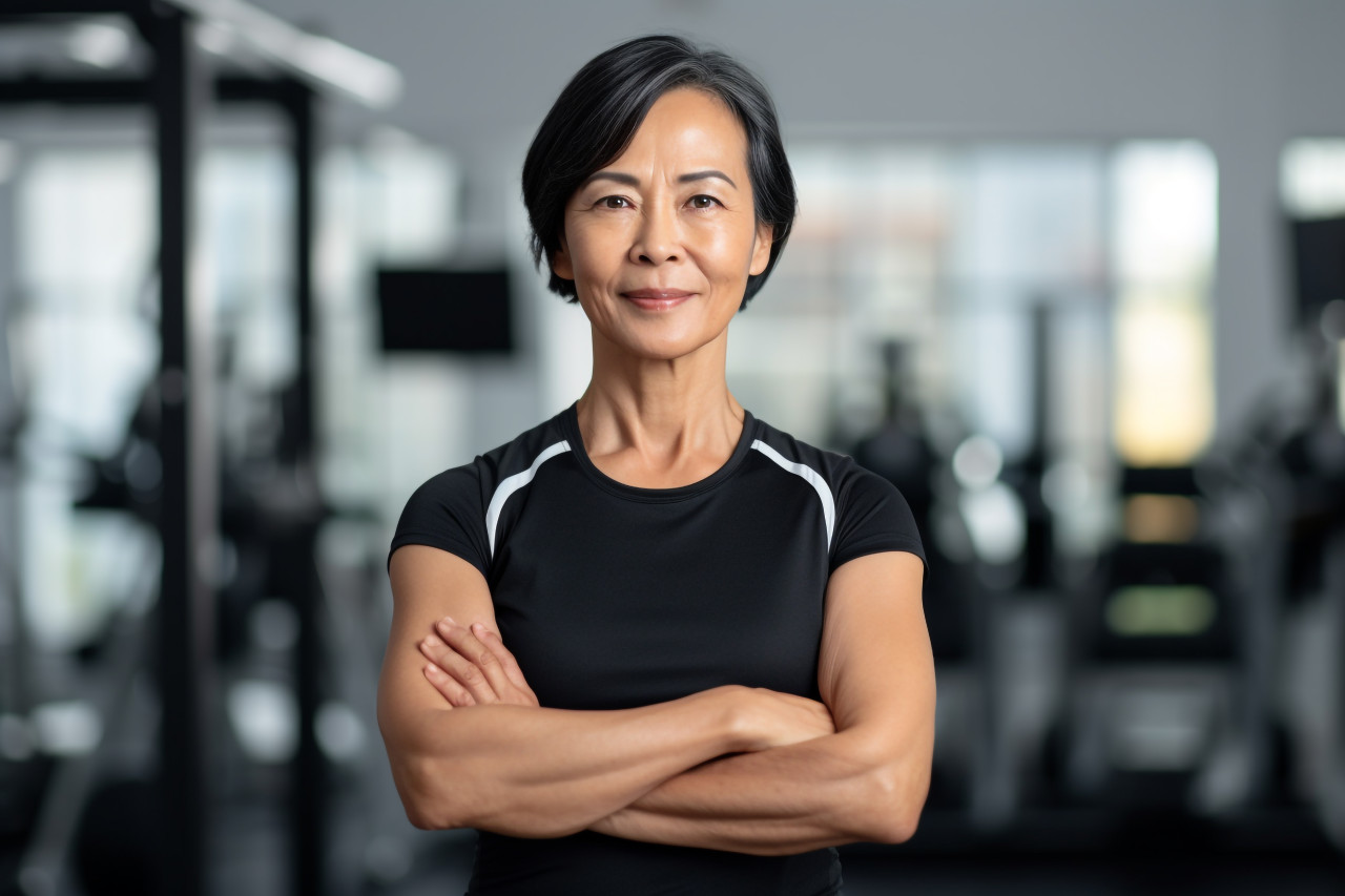 Confident asian businesswoman in office smiling at camera