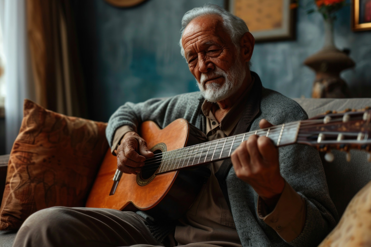 A senior gentleman playing guitar seated on a couch, images of senior citizens
