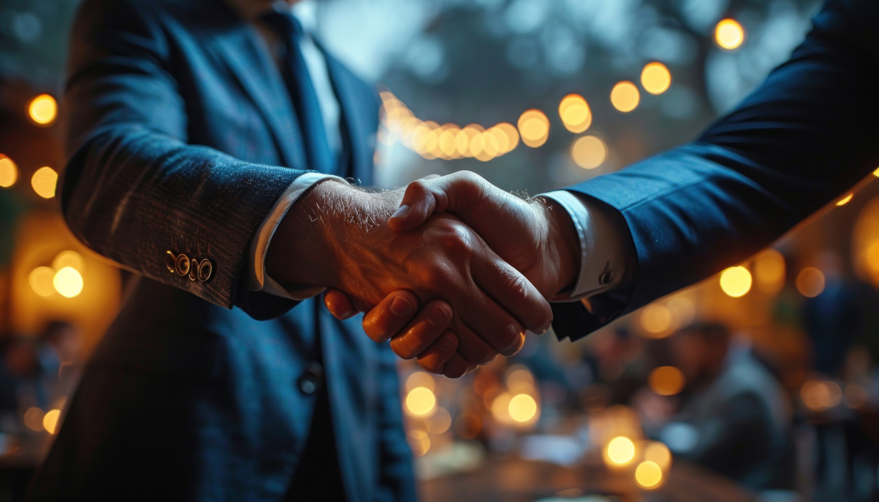 Two business men sealing the deal with a handshake, business meeting photo