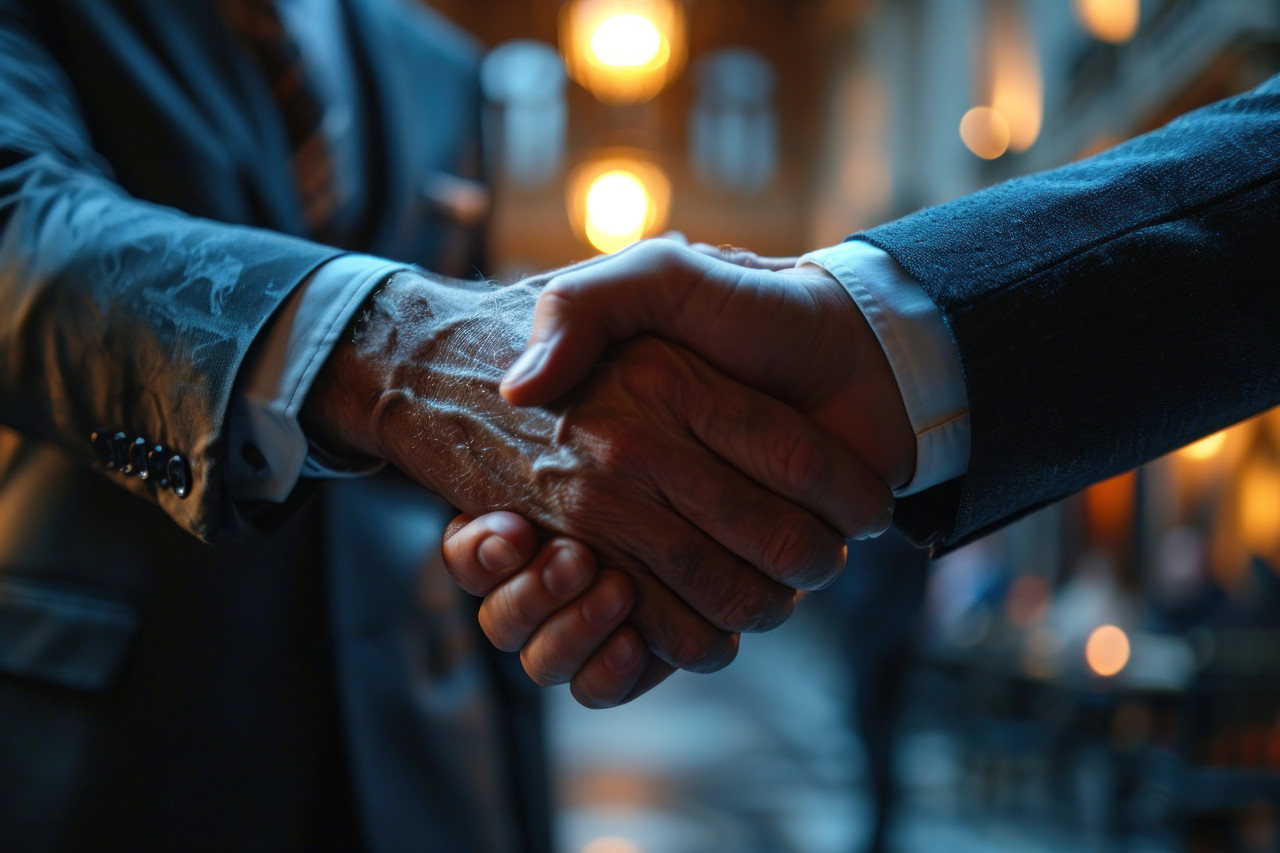 Business professionals engage in a handshake gesture, business meeting photo