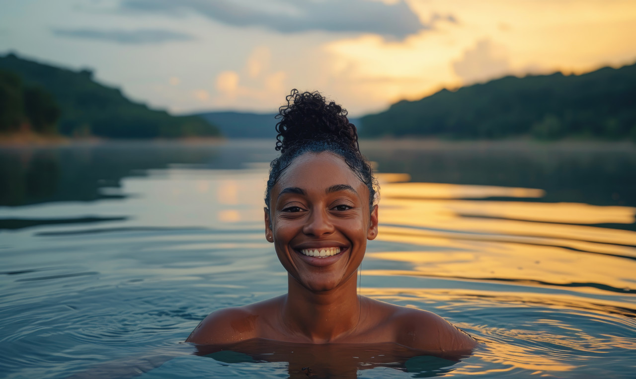 Woman joyfully swims in the lake, diverse water uses picture