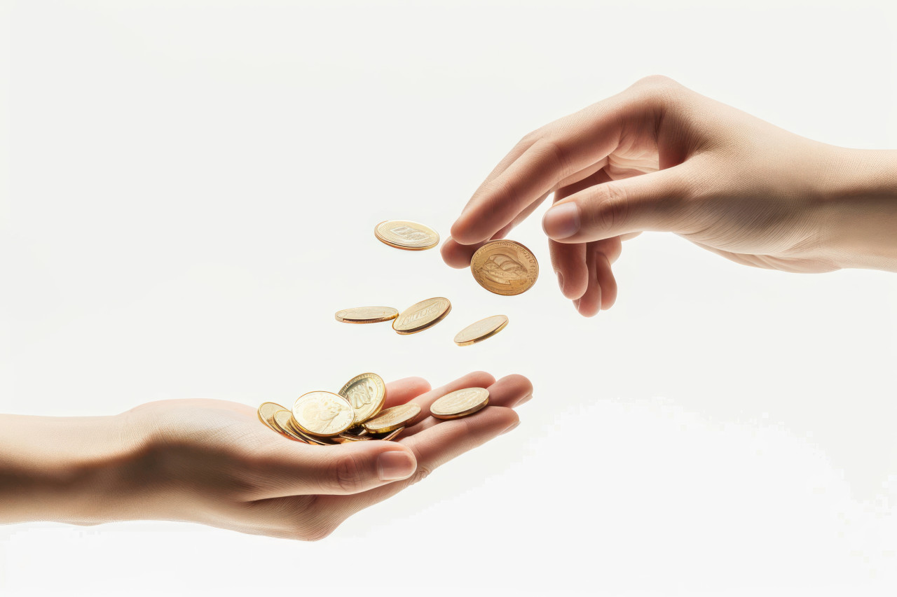 Two hands reaching for coins symbolizing desire for wealth and financial success, forgiveness concept