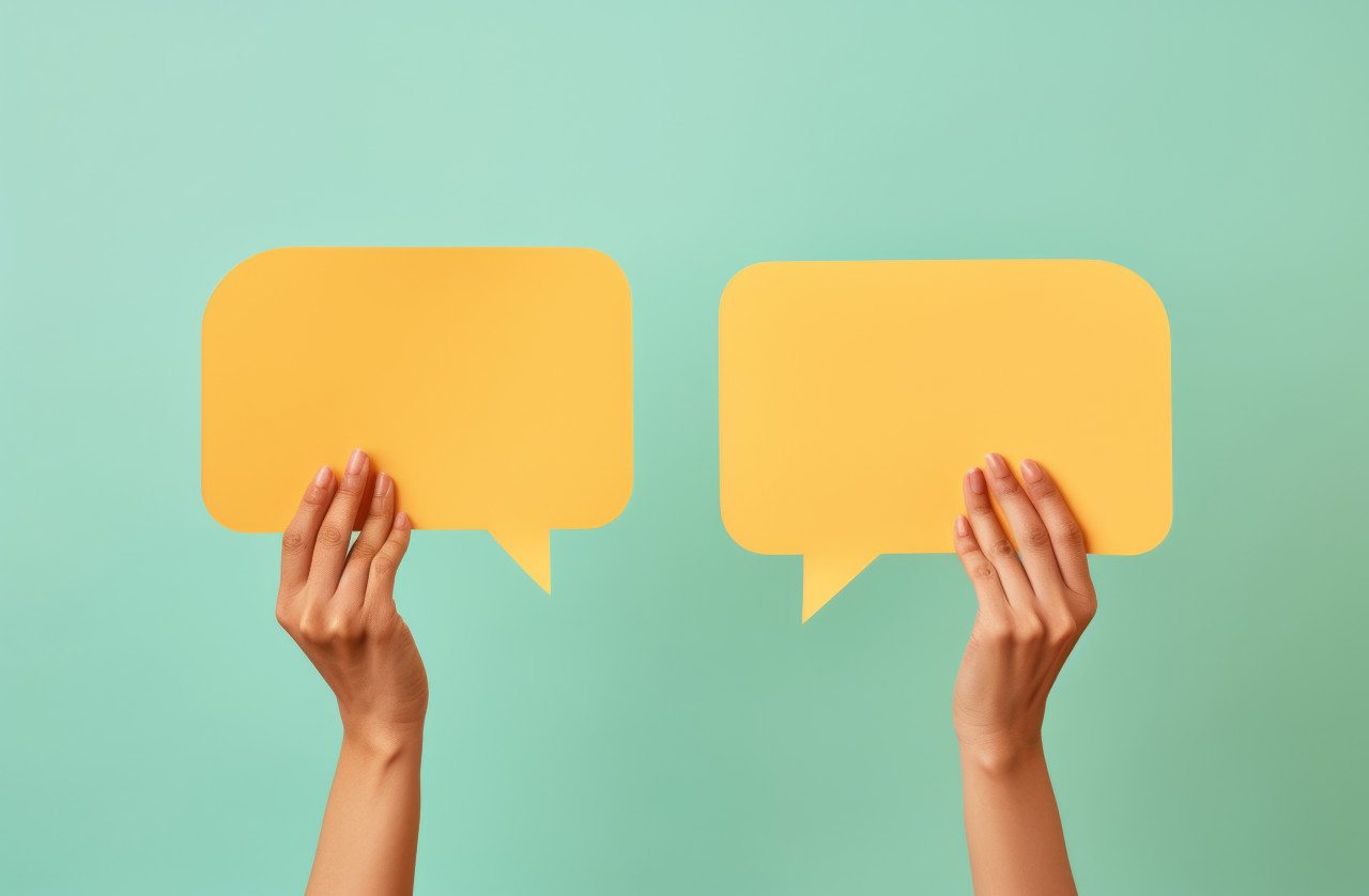 Hands hold up a yellow speech bubble ready for your creative messages and expressions, branding marketing photo