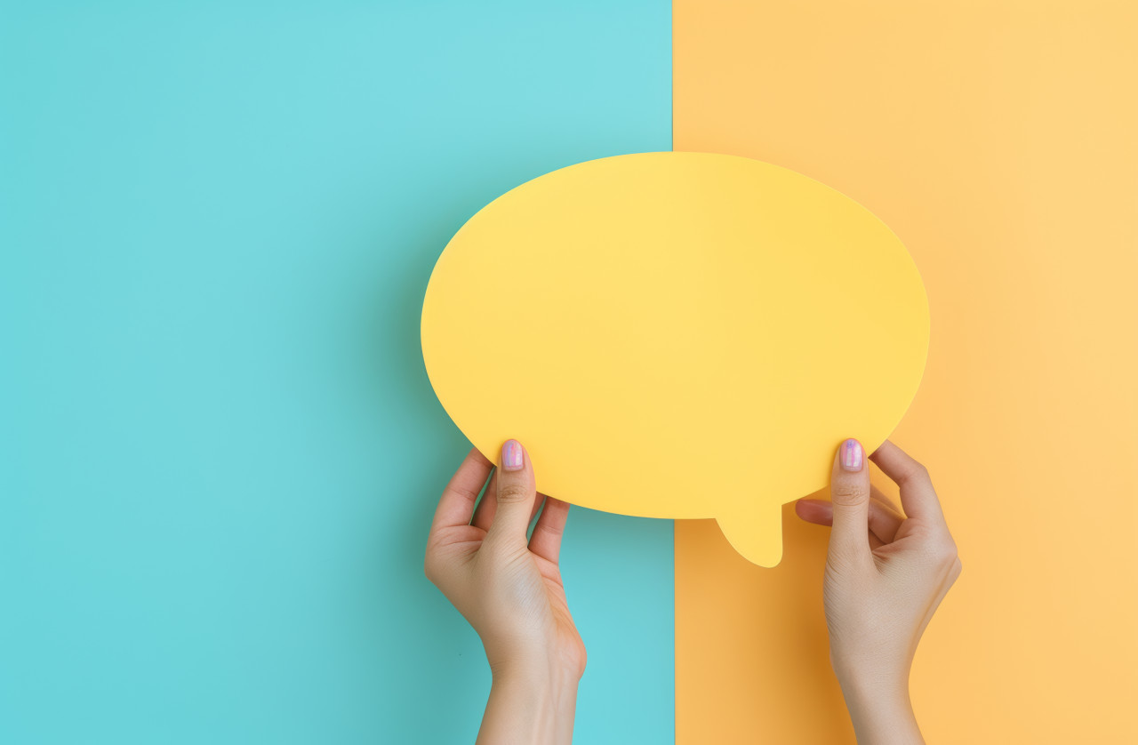 Two hands showcase a yellow speech bubble ready for your messages, branding marketing concept