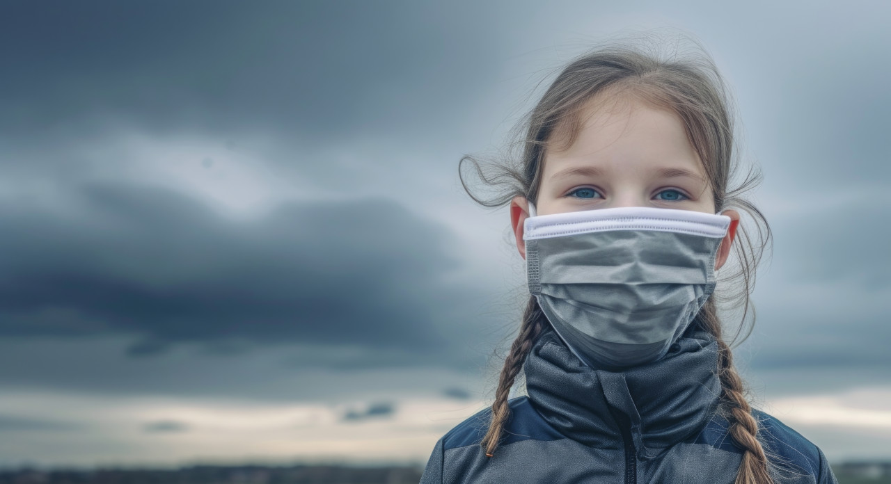 Young girl wearing protective mask, air pollution and smog picture