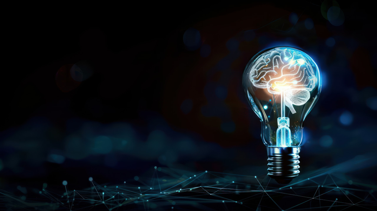 Abstract light bulb with glowing brain inside on dark background symbolizing creativity and intelligence