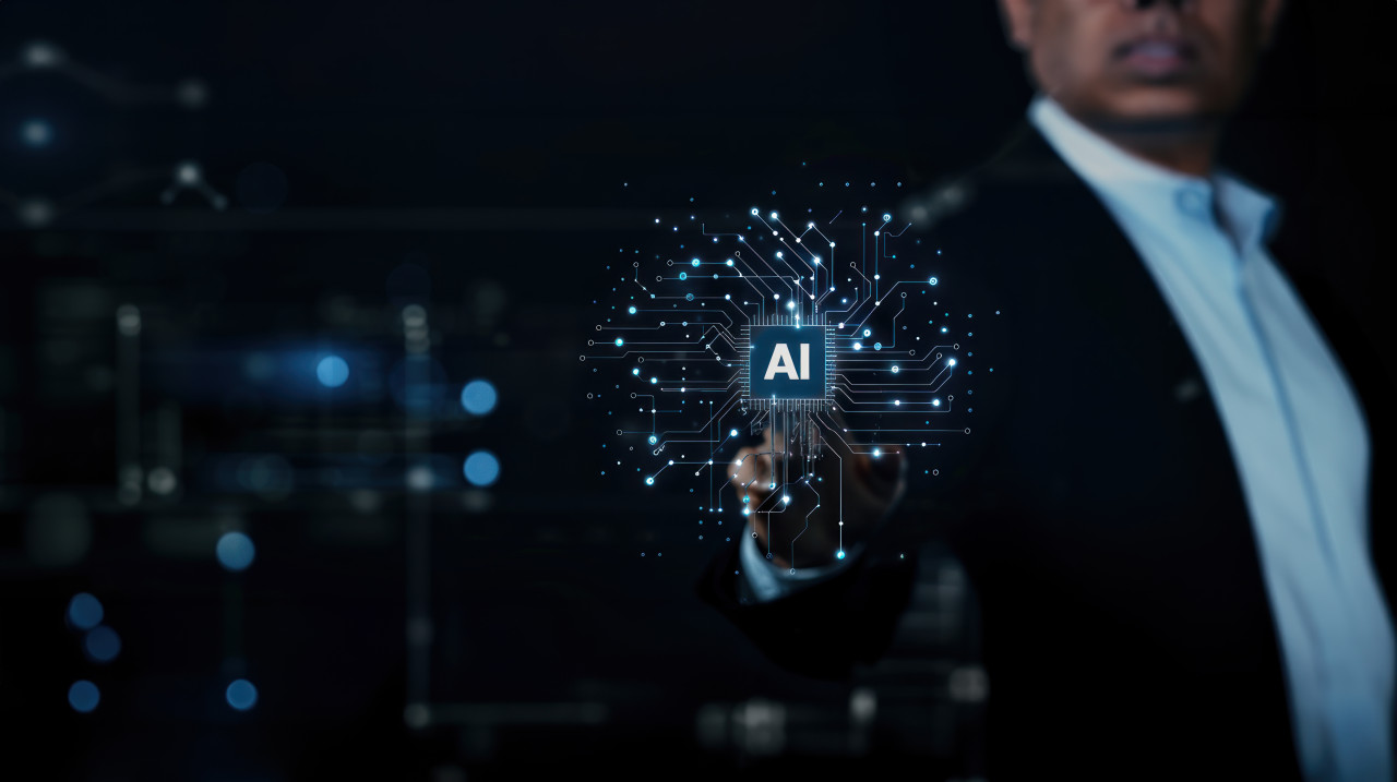 Businessman touching ai icon with finger on virtual screen showing technology and innovation concept