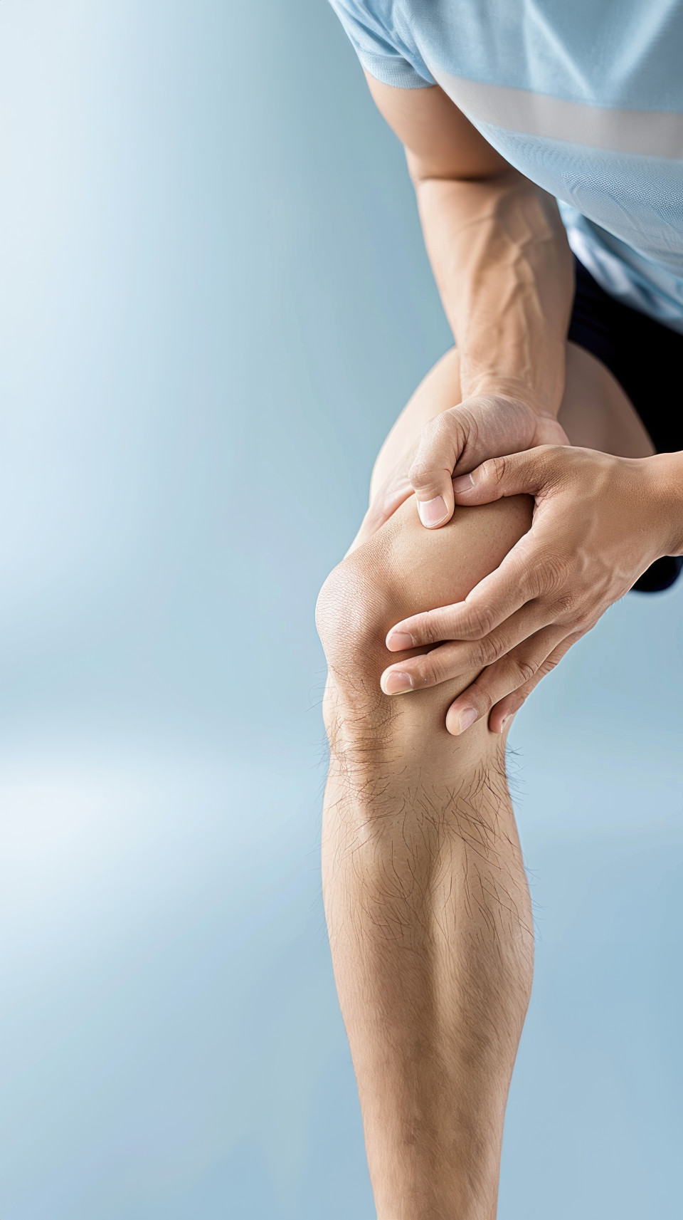 An athlete holds their knee in pain with a focus on the leg and hand showing the healthcare and knee pain concept