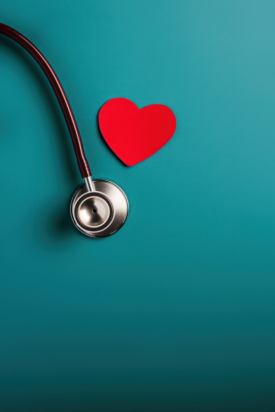 Stethoscope and dark red heart on a blue background emphasizing heart health, world heart day, medical heart