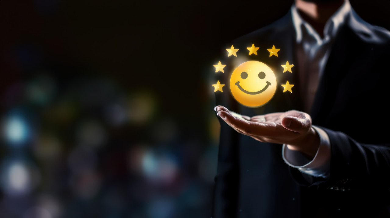 Businessman holding yellow smiley face icon with six stars on dark background representing customer satisfaction and feedback, professional service evaluation, quality ratings