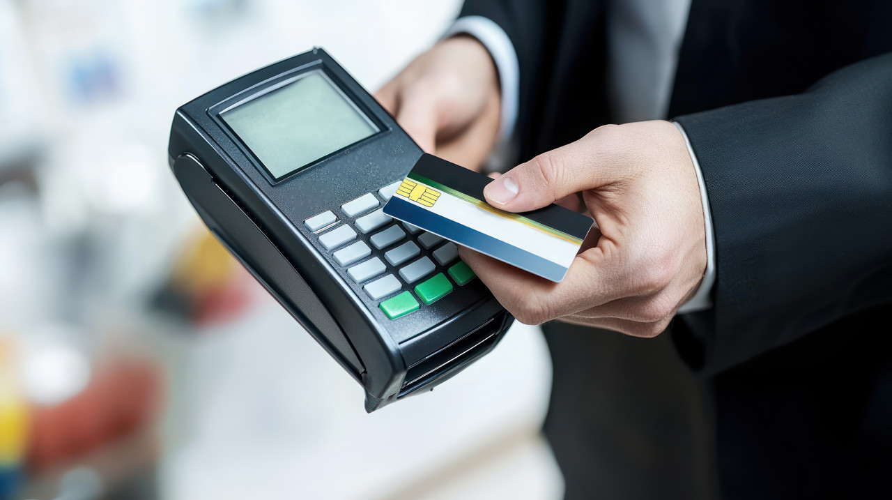 Business person using a modern payment terminal to pay by bank card atm service concept