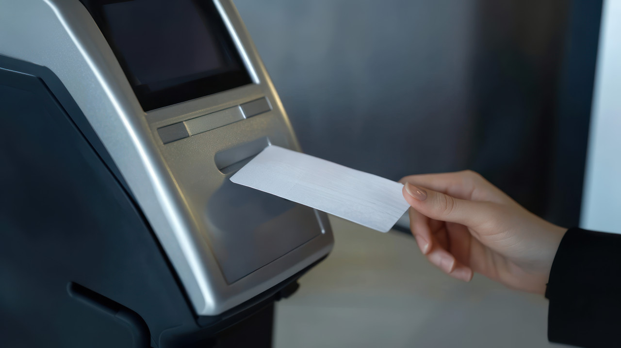 Credit card terminal with printed receipt paper coming out of it atm service idea