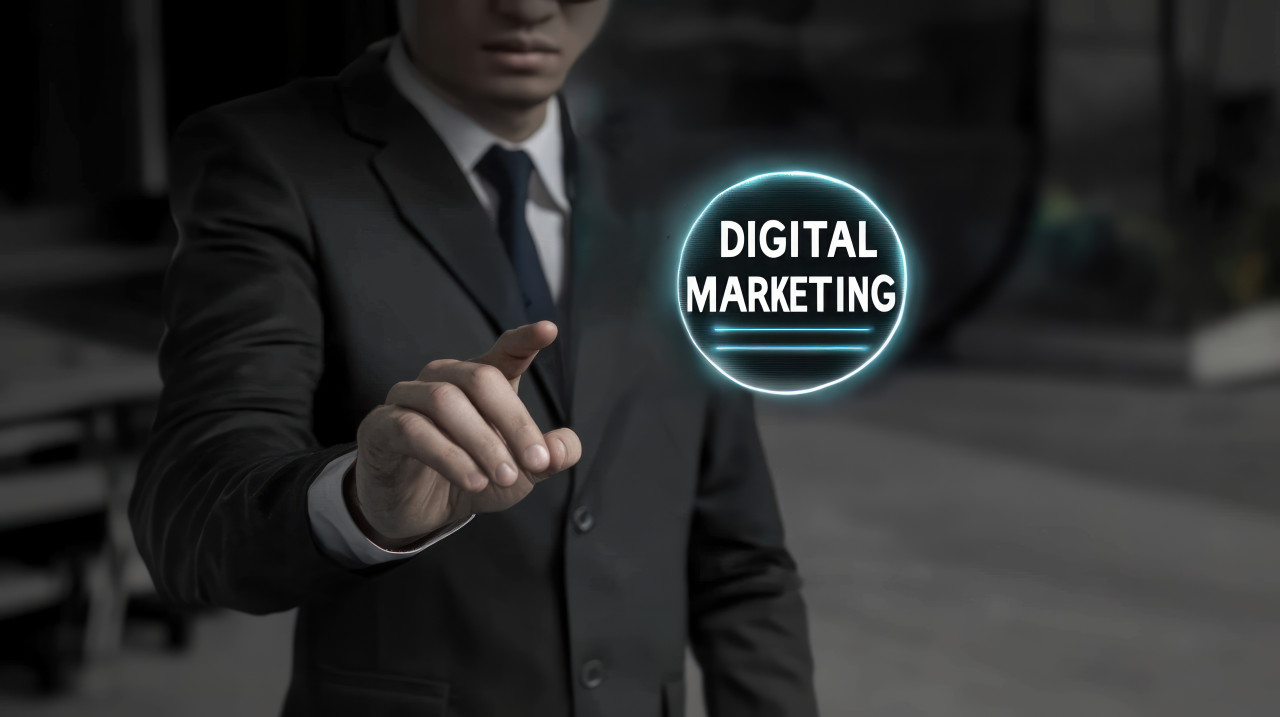 A businessman reaching out to touch a digital marketing icon with the text digital marketing floating in the air, symbolizing interaction, strategy engagement, digital marketing