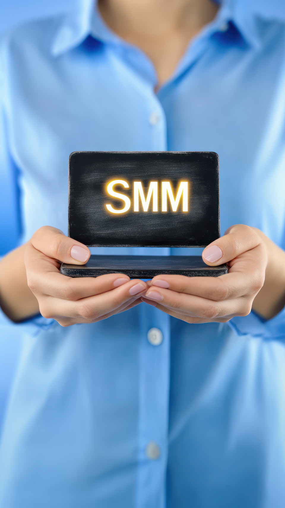 Businesswoman holding a small blackboard with smm and glowing speech bubble in her palms, symbolizing digital communication and social media marketing, online interaction, marketing engagement