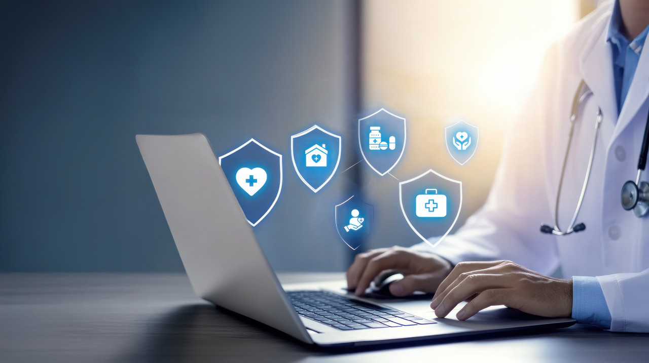 Doctor with advanced laptop medical icons and shield symbols floating around, patient portals, data protection, patient security