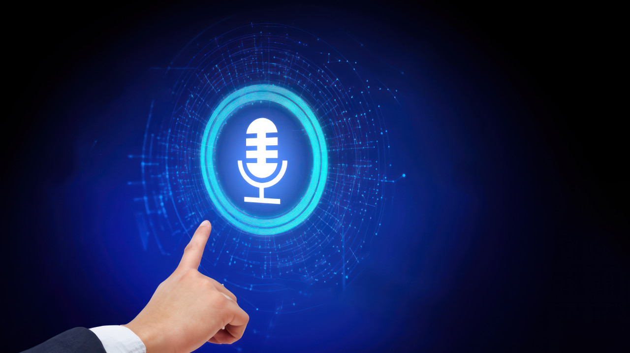 Finger touching podcast icon on virtual screen with microphone and symbols, representing podcast income, interactive digital tools, podcast monetization