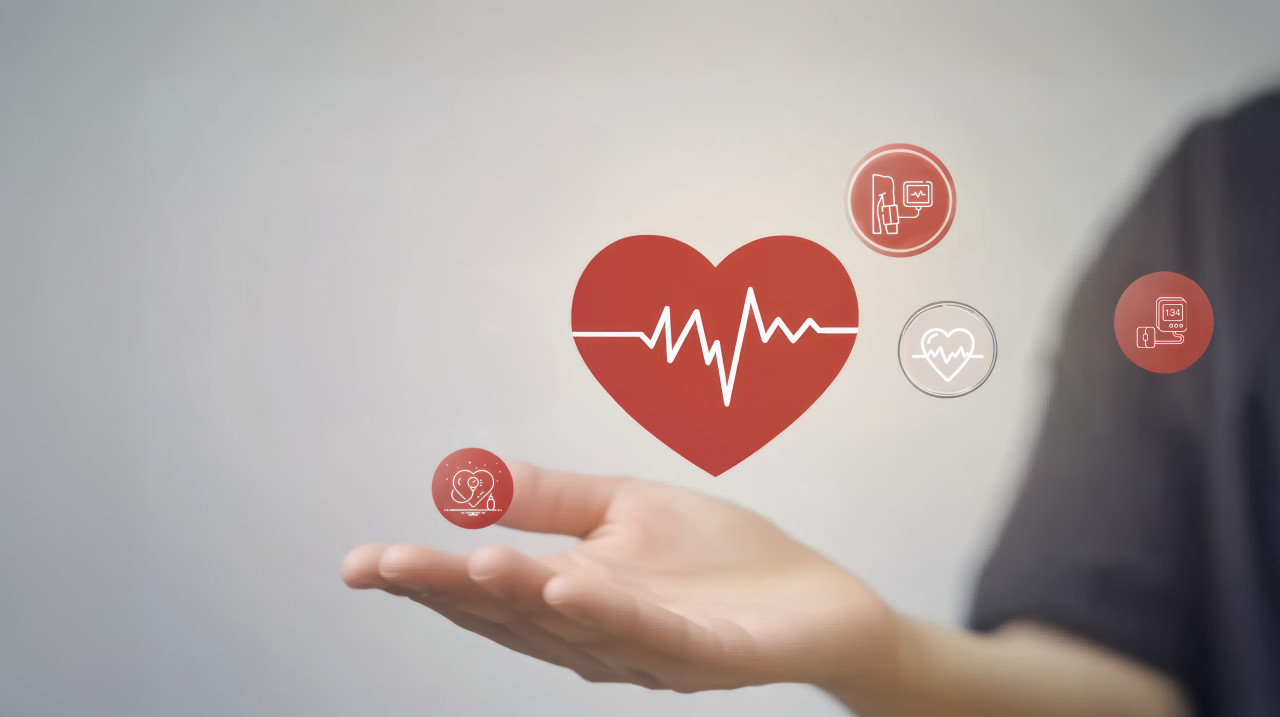 Person hand with icon of heart and pulse lines symbolizing healthcare health services, heartbeat monitoring, high bp control, diastolic health