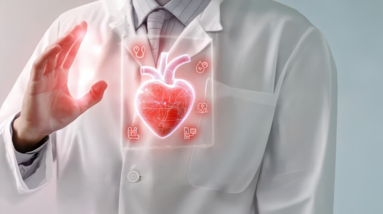 Doctor in white coat with stethoscope holds hand to digital heart on transparent screen, patient care, digital health tools, heart monitoring