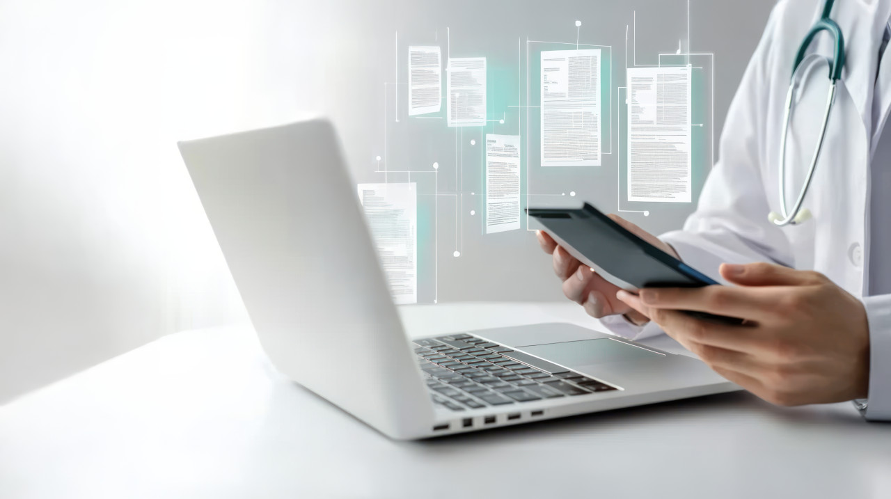 Doctor using an ai powered medical document reading app on their laptop with digital documents floating around them, representing health records, medical care