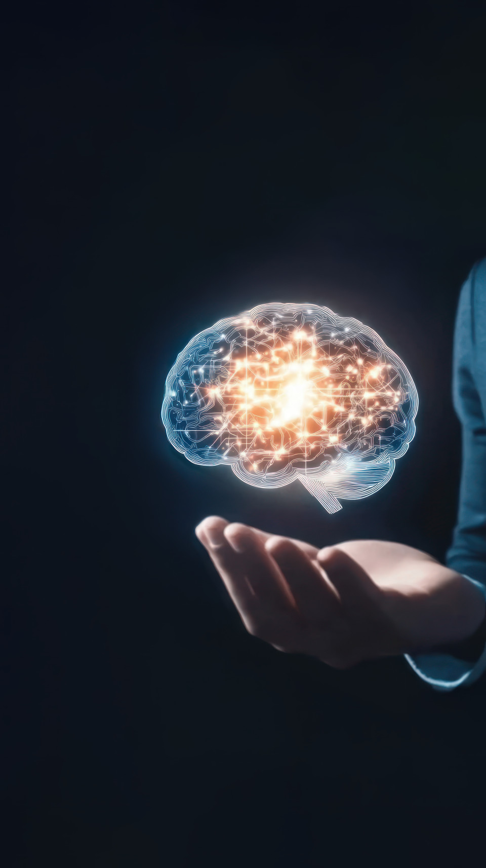Businessman holding a glowing brain hologram in his hand, symbolizing neural innovation, ms awareness, and muscular sclerosis insights in a modern context