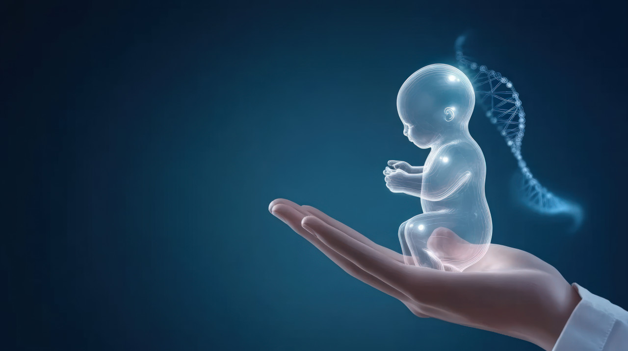 Hand holds transparent baby figure with dna strands on a blue background, prenatal care and genetic study for better maternity hospital care