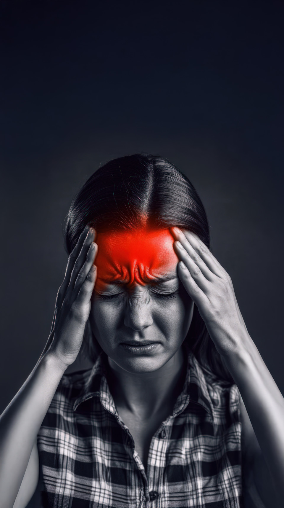 A woman holds the sides of her face and temple with a red glow of pain on her head, symbolizing neurology, ocd, schizophrenia, and pediatric neurologist concepts