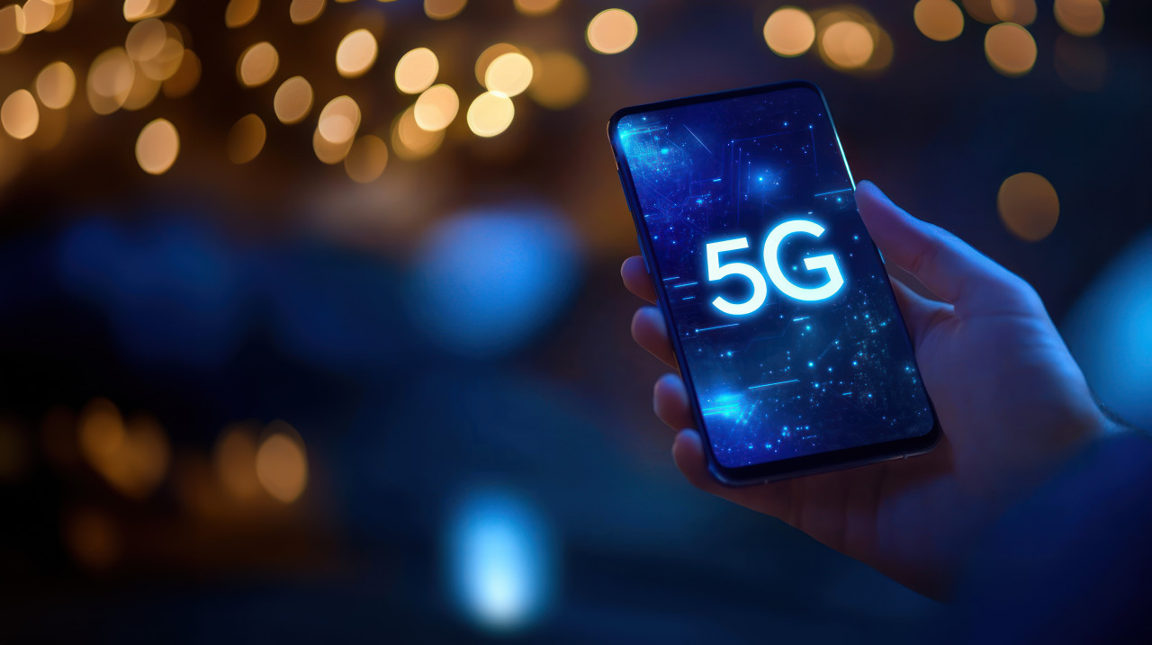 A person holding a smartphone with the 5g network glowing on the screen, representing internet speed, 5g activation, data flow, and 5g expansion