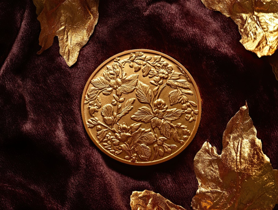 Ornate coin with embossed filigree, intricate patterns shining in gold leafing, a symbol of wealth and heritage, edible gold leaf, antique currency concept