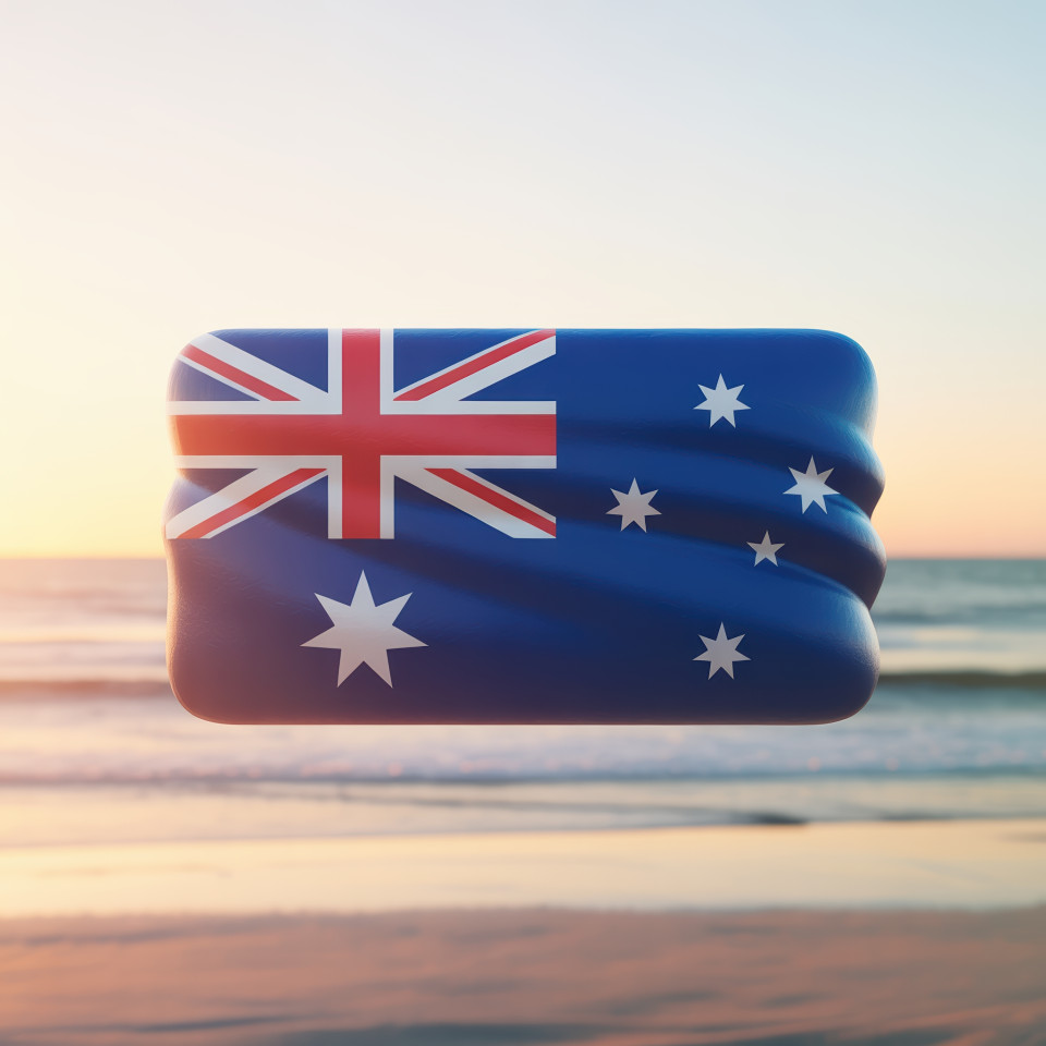Australian flag icon with soft waves floating gently over a golden beach sunset background, minimal and clean style, fits digital branding mockups