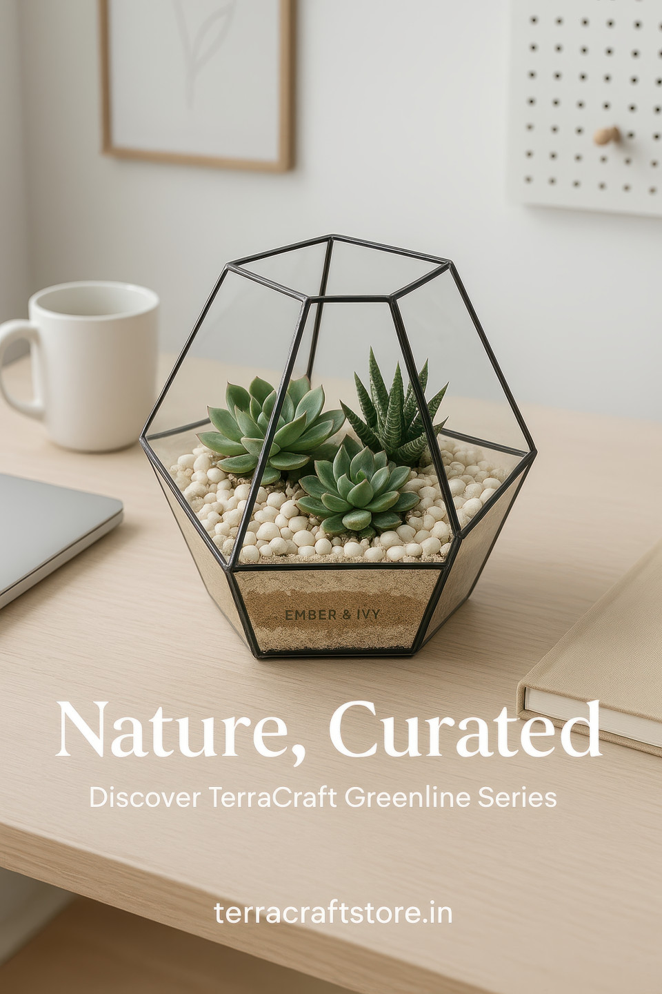 Glass terrarium with succulents and pebbles on wooden desk beside mug, notebook and laptop in clean scandinavian room, home decor products chat gpt prompts