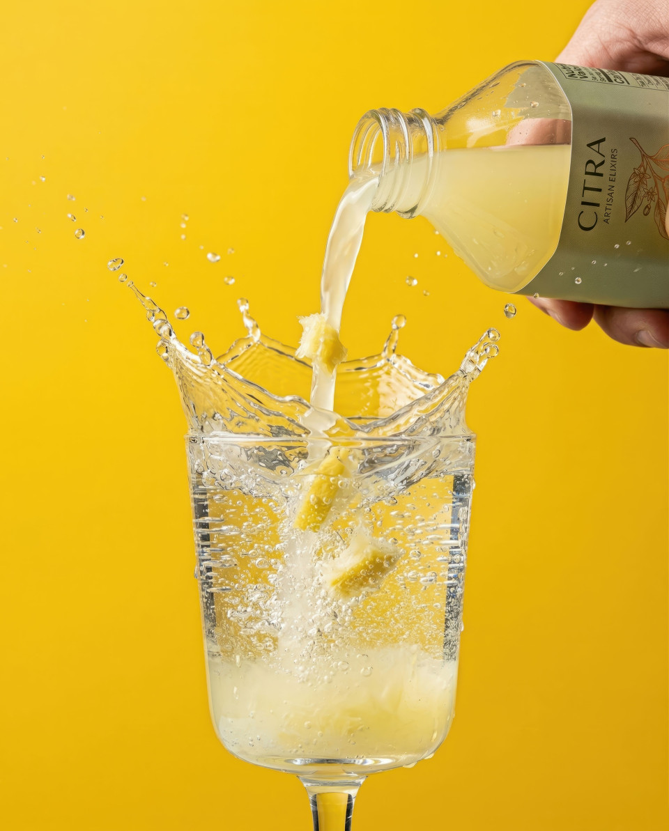 Lemon beverage splash pouring into sparkling water studio shot google gemini prompt