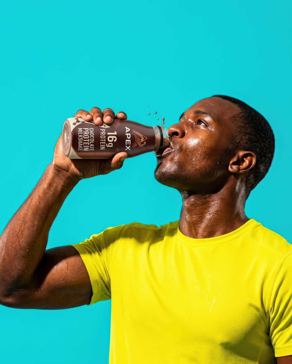 Athletic man drinking protein shake against turquoise wall google gemini prompt