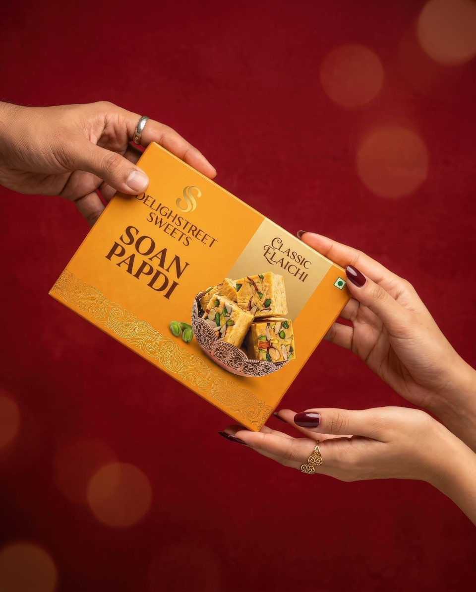 Festive gift exchange sweets box hands top view red background google gemini prompt