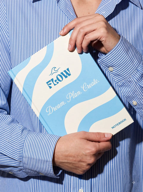 Commercial Fashion Lifestyle Product Photography Prompt Close-Up Torso Holding Patterned Hardcover Book