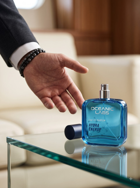 Editorial Lifestyle Product Photography Prompt Blue Cologne Flacon on Glass Table in Private Jet