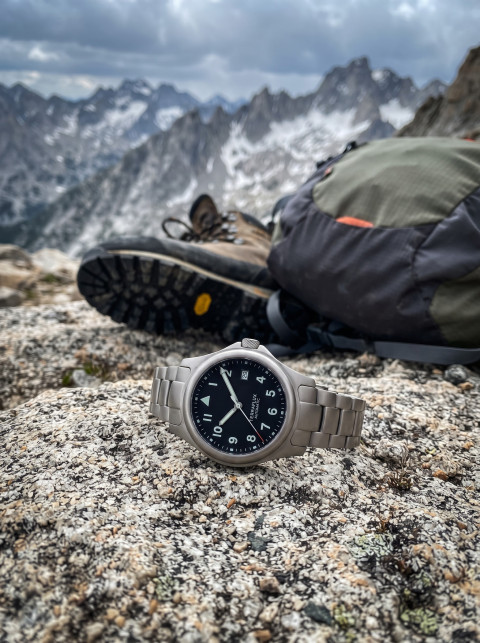 Expedition Lifestyle Product Photography Prompt Adventure Watch with Hiking Gear on Granite Ridge
