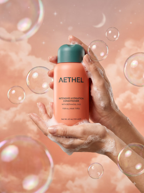 Hair Conditioner Bottle in Foamy Hands with Bubbles