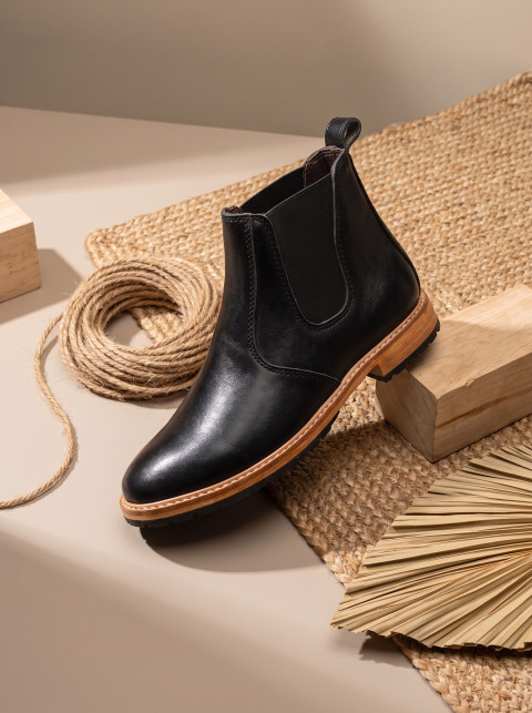 Leather Chelsea Boot on Woven Jute Mat and Wood Block