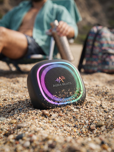 Outdoor Adventure Product Photography Prompt Sand-Resistant Outdoor Speaker on Pebble Beach