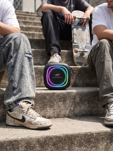 Streetwear Lifestyle Product Photography Prompt Portable RGB Speaker on Urban Concrete Stairs