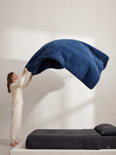 Woman Floating Weighted Blanket Commercial Product Photography Prompt Minimalist Bedroom Loft